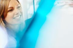Close up - smiling woman looking away.