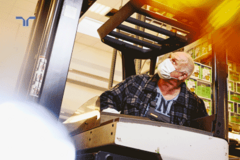 man wearing a mask working with a forklift