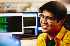 man working at computer smiling