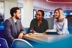 three people in a meeting