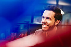 man smiling at his desk