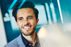 man smiling at his desk