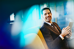 man smiling at his desk