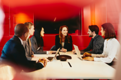 people working in an office boardroom