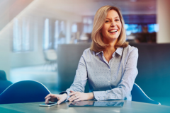 blonde woman in an office smiling