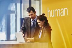 two people working on a laptop