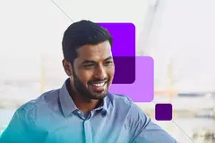 man smiling at his desk