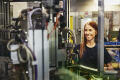 Woman operating a machine on a production site. 