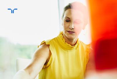 woman in yellow looking offscreen