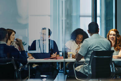 people working in an office boardroom