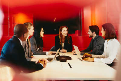 people working in an office boardroom