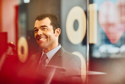 man smiling in an office boardroom