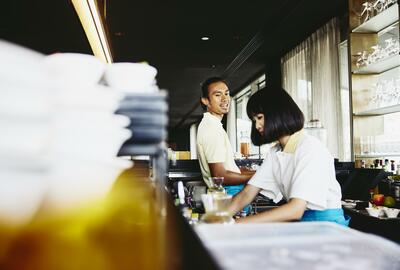 Man and woman bar tending.