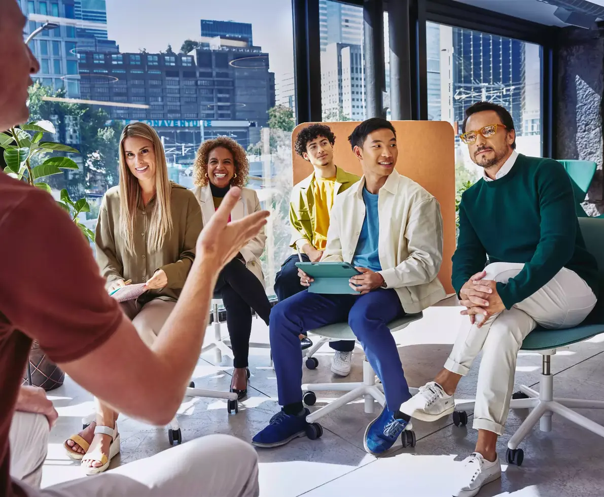 Group of people having a meeting, in a room with glass windows