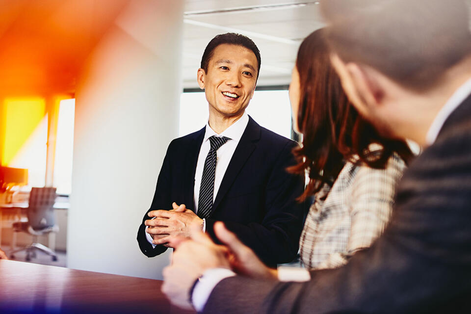 Man speaking to colleagues